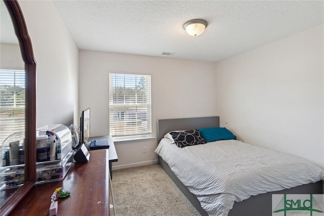 carpeted bedroom with a textured ceiling