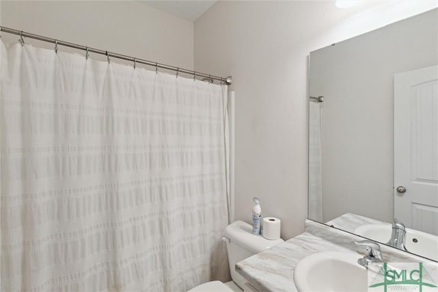 bathroom featuring vanity, curtained shower, and toilet