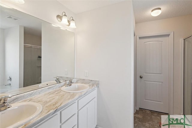 bathroom featuring vanity, independent shower and bath, and a textured ceiling