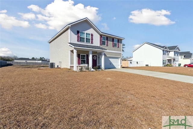 view of front of home with covered porch, central AC, and a garage