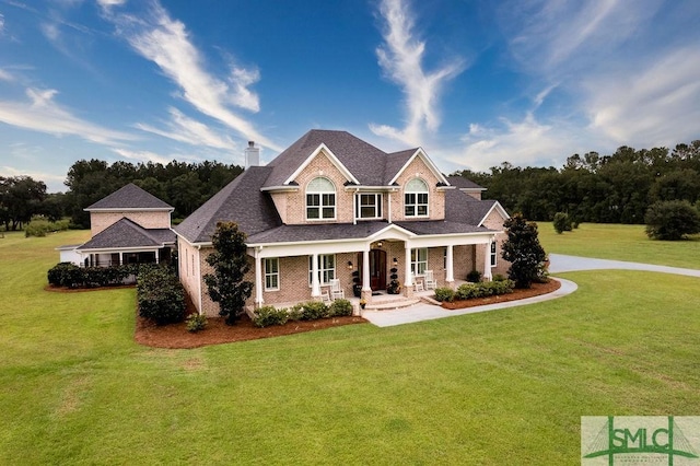 craftsman house featuring covered porch and a front lawn