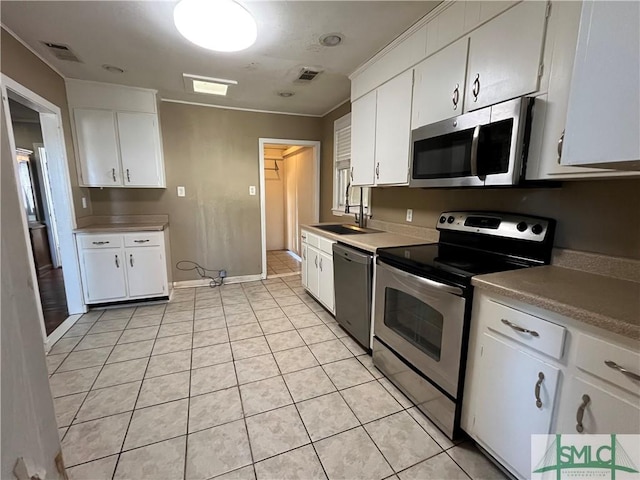 kitchen with sink, stainless steel appliances, and white cabinets