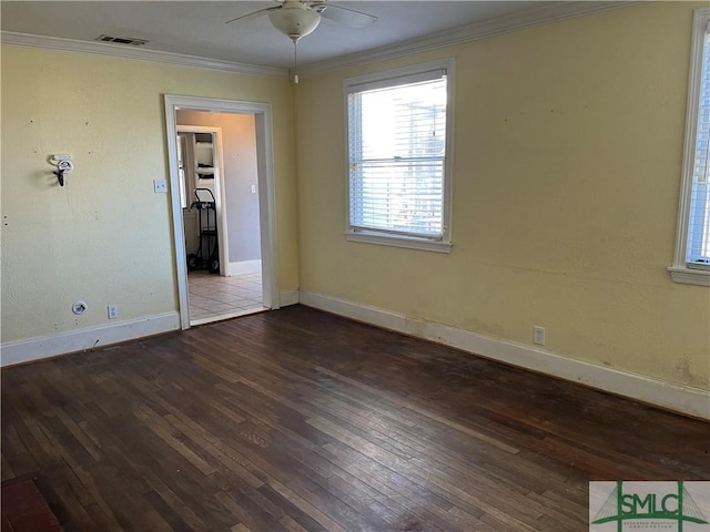 empty room featuring ceiling fan, ornamental molding, and dark hardwood / wood-style floors