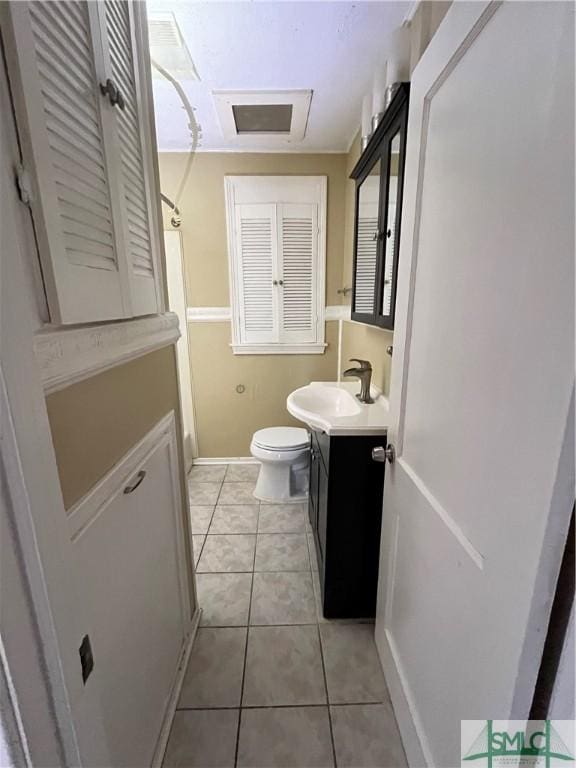 bathroom with tile patterned flooring, vanity, and toilet