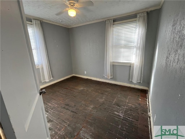 spare room featuring crown molding and ceiling fan