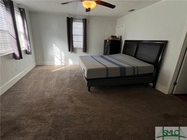 unfurnished bedroom with ceiling fan, ornamental molding, and carpet floors