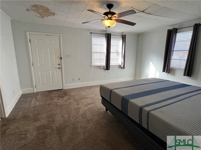 carpeted bedroom featuring crown molding and ceiling fan