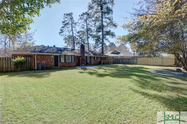 view of yard featuring central AC and a fenced backyard