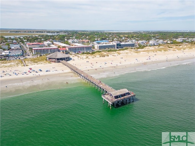 drone / aerial view with a water view and a beach view