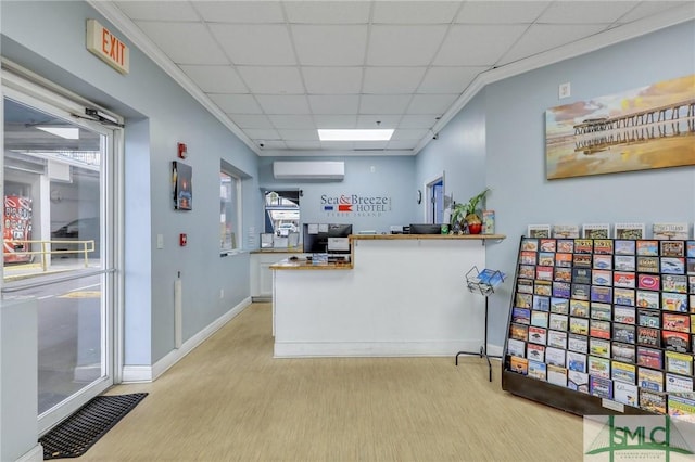 16 Tybrisa St Unit 127, Tybee Island, GA 31328 - kitchen featuring a wall unit AC, light wood-style floors, a drop ceiling, and a peninsula