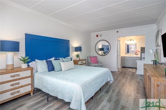 bedroom featuring ensuite bathroom, dark hardwood / wood-style floors, and ornamental molding