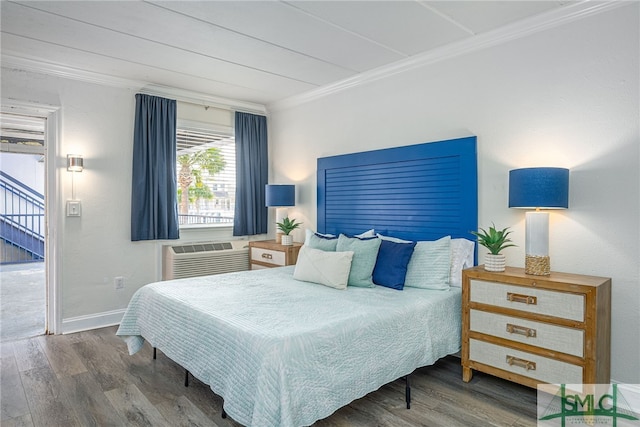 bedroom featuring dark hardwood / wood-style floors, ornamental molding, and a wall mounted AC