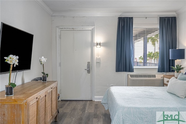 16 Tybrisa St Unit 127, Tybee Island, GA 31328 - bedroom featuring ornamental molding, dark wood finished floors, and a wall unit AC