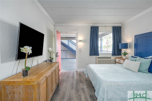 bedroom featuring hardwood / wood-style floors, a wall unit AC, and ornamental molding