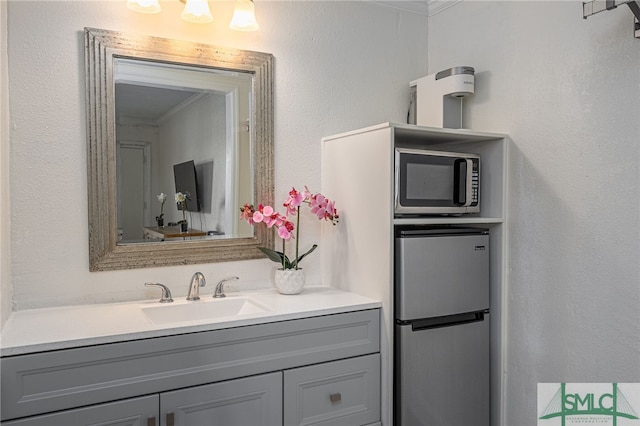 16 Tybrisa St Unit 127, Tybee Island, GA 31328 - bathroom featuring crown molding and vanity