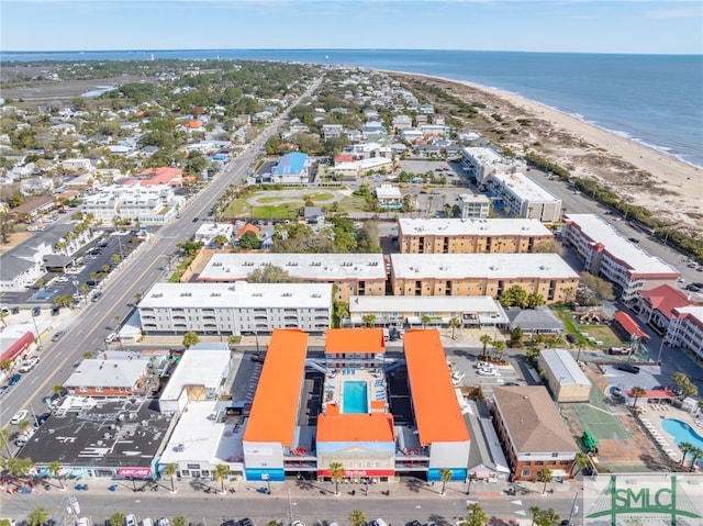 birds eye view of property featuring a beach view and a water view