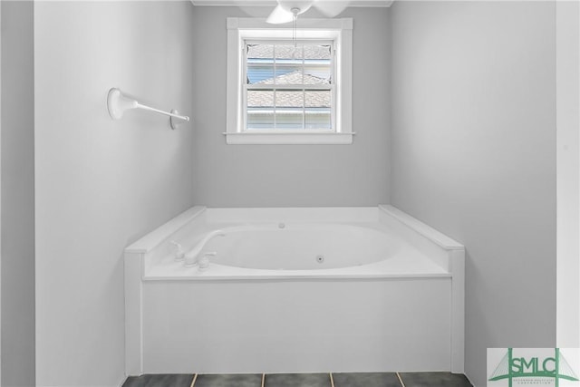 bathroom with a tub to relax in and tile patterned floors