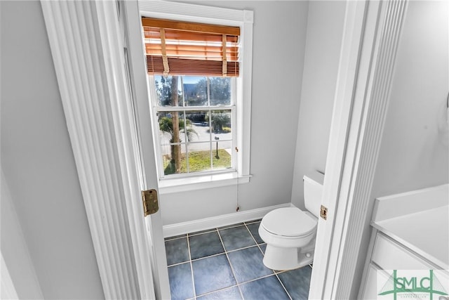 bathroom with toilet and tile patterned floors