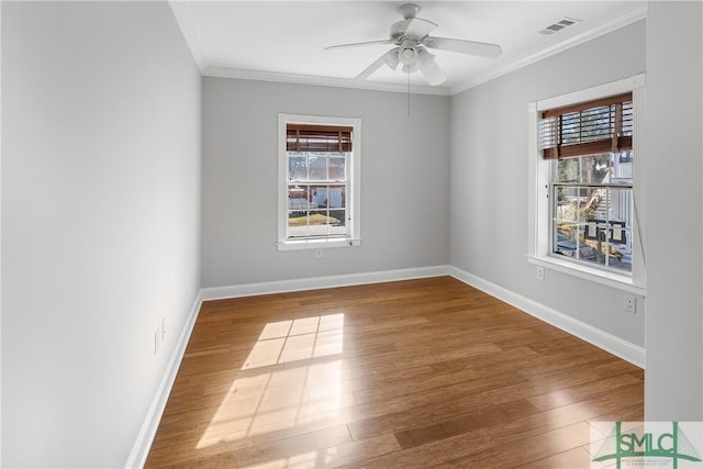 unfurnished room featuring wood-type flooring, ceiling fan, a healthy amount of sunlight, and crown molding