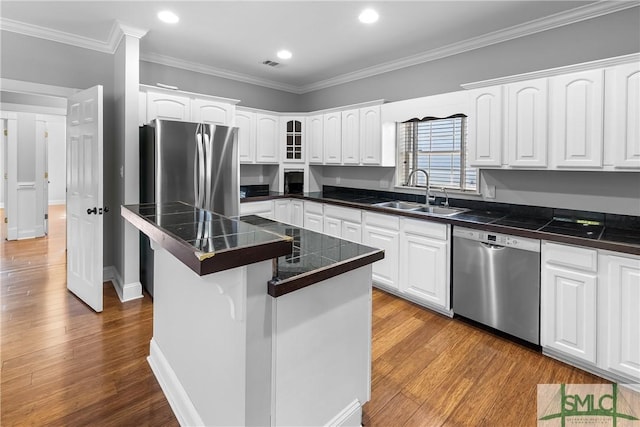 kitchen featuring stainless steel dishwasher, a center island, crown molding, white cabinetry, and sink