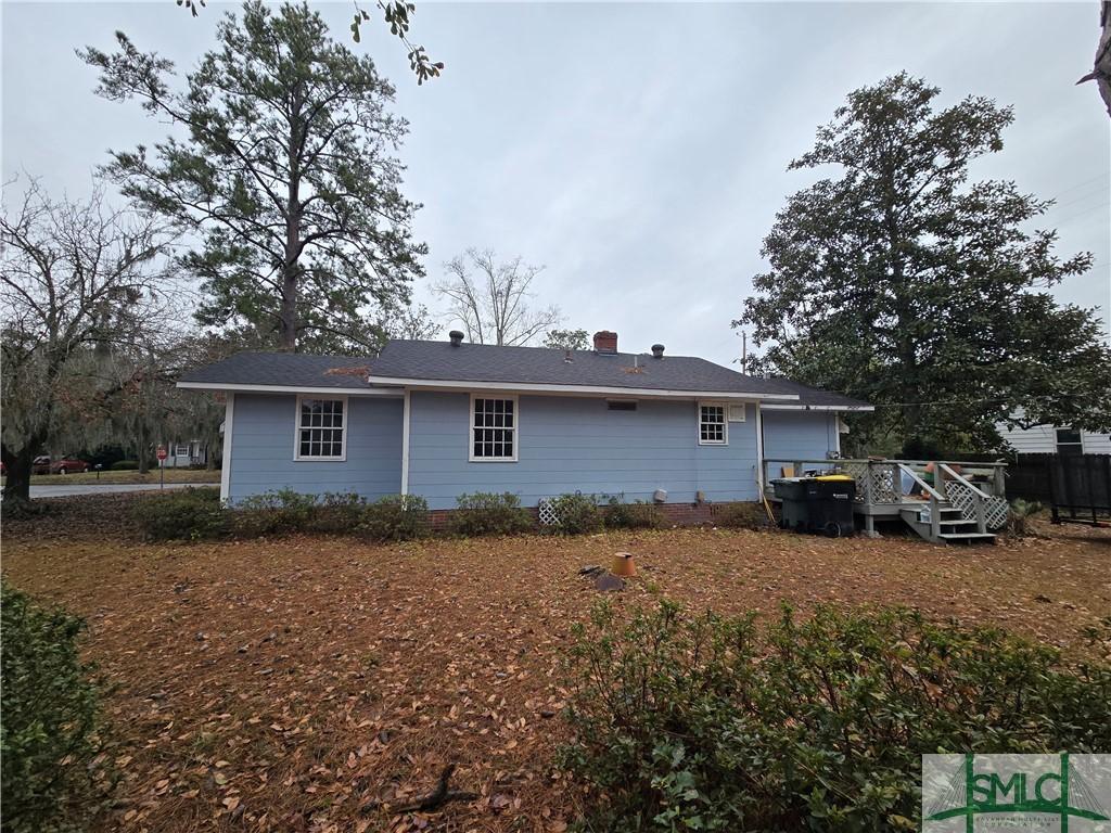 rear view of property featuring a deck