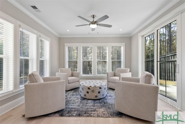 living room featuring plenty of natural light, ceiling fan, and light hardwood / wood-style flooring