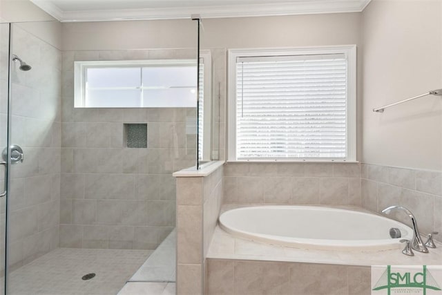 bathroom with crown molding and shower with separate bathtub