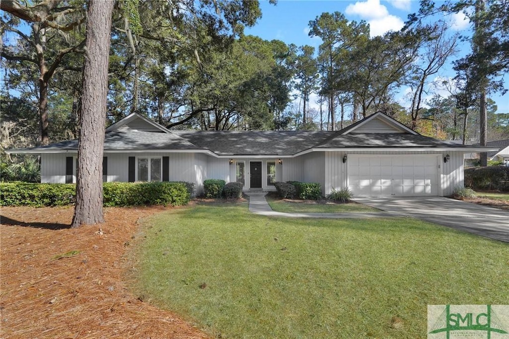 single story home featuring a front lawn, a garage, and french doors