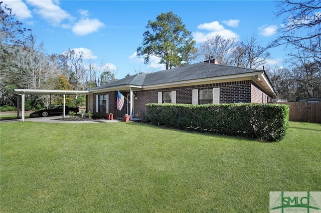 view of front of property with a carport and a front lawn