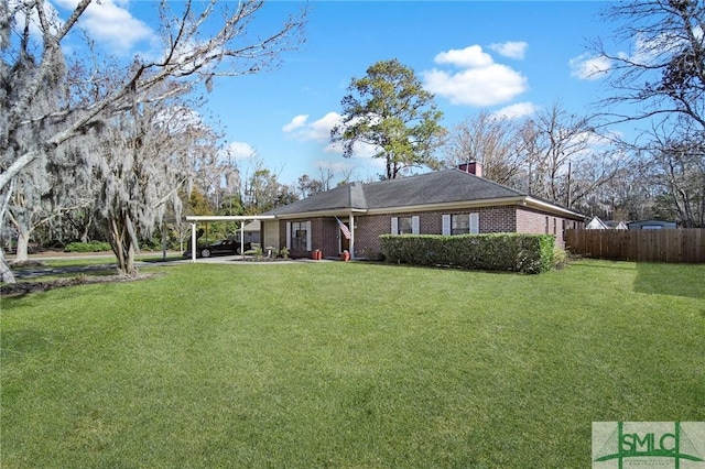 ranch-style home with a carport and a front lawn