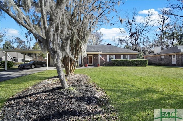 exterior space featuring a front lawn and a carport