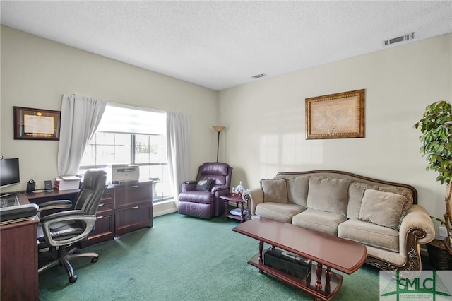 carpeted home office featuring a textured ceiling