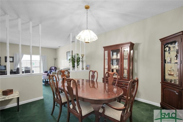 dining space with a notable chandelier and dark carpet