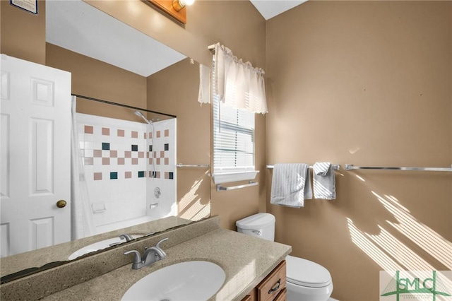 bathroom featuring a shower, vanity, and toilet