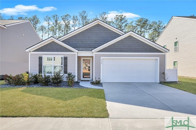 view of front of home featuring a front yard and a garage