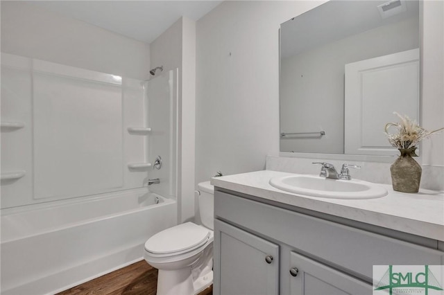 full bathroom with vanity, hardwood / wood-style flooring, toilet, and tub / shower combination