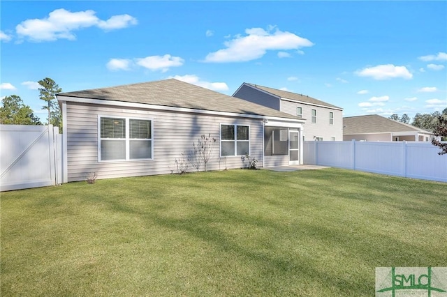 rear view of house with a lawn