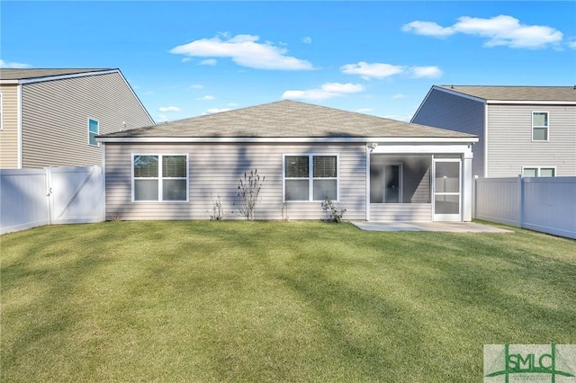 rear view of house featuring a lawn