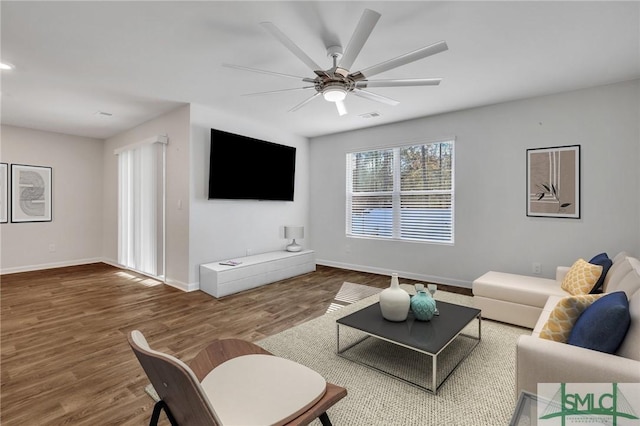 living room featuring hardwood / wood-style flooring and ceiling fan