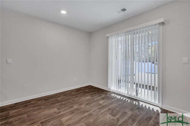 unfurnished room with dark hardwood / wood-style floors