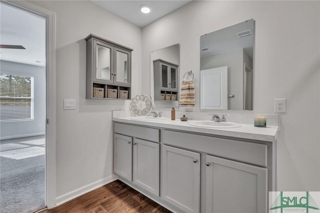 bathroom featuring vanity, hardwood / wood-style flooring, and ceiling fan