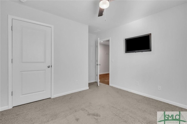 unfurnished bedroom with ceiling fan and light carpet