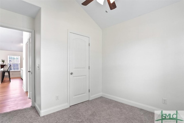 bedroom featuring ceiling fan, light colored carpet, and lofted ceiling