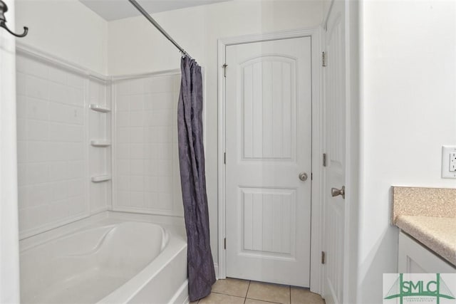 bathroom featuring tile patterned flooring, vanity, and shower / bath combo with shower curtain