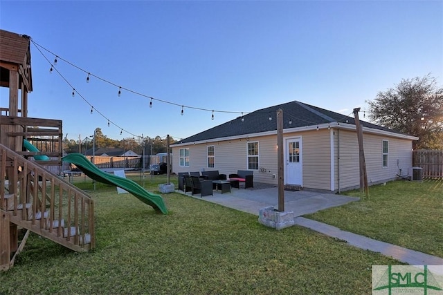 exterior space featuring a trampoline, an outdoor hangout area, a yard, a patio area, and a playground