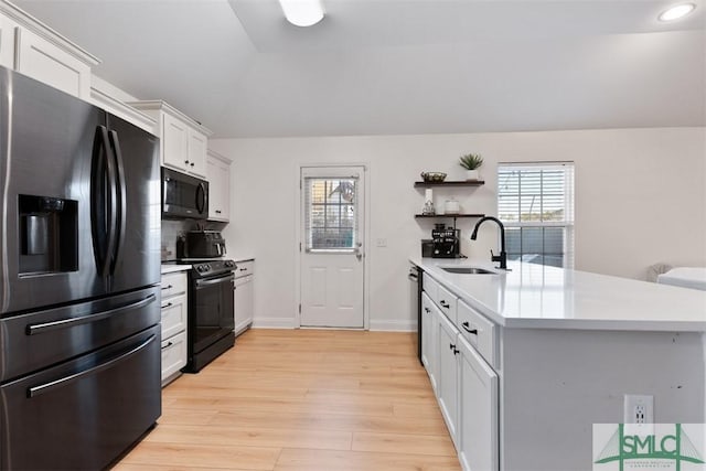 kitchen with sink, dishwasher, black electric range, stainless steel fridge with ice dispenser, and white cabinetry