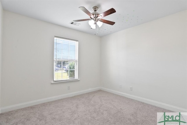 carpeted spare room featuring ceiling fan