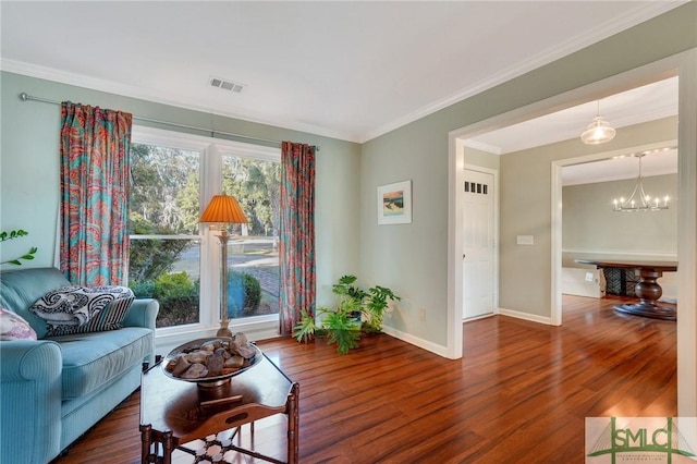 living room with a chandelier, dark hardwood / wood-style floors, and crown molding