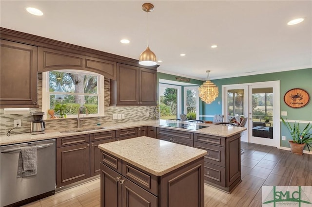 kitchen with a center island, stainless steel dishwasher, pendant lighting, decorative backsplash, and black electric stovetop