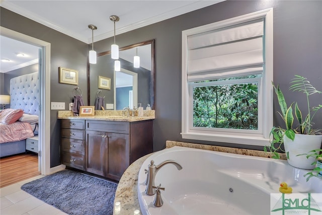 bathroom with tile patterned flooring, a bathtub, vanity, and ornamental molding